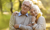 A senior couple smiling for the camera